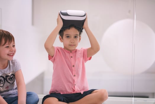 kids using virtual reality headsets at home photo