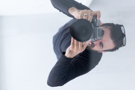young Photographer takes pictures with DSLR camera photo