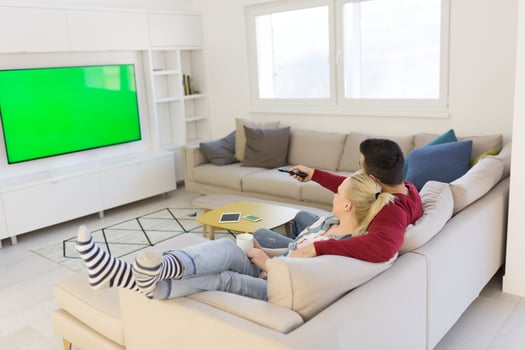 Young couple on the sofa watching television photo