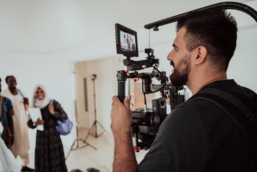 A videographer in a home studio captures a group of modern students with a professional camera. photo