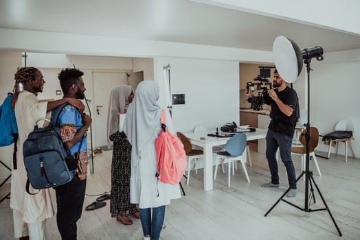 A videographer in a home studio captures a group of modern students with a professional camera. photo