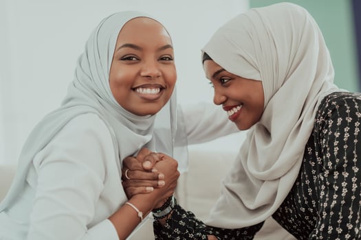 African woman arm wrestling conflict concept, disagreement and confrontation wearing traditional islamic hijab clothes. Selective focus photo