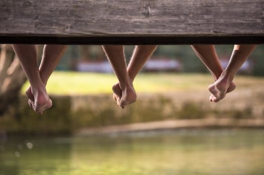 people sitting at wooden bridge photo