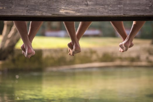 people sitting at wooden bridge photo