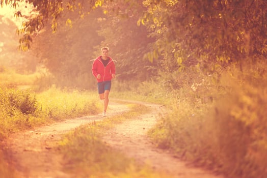 man jogging along a country road photo