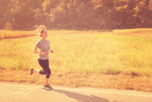 woman jogging along a country road photo