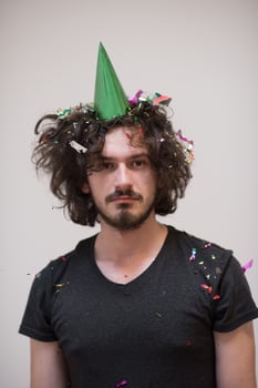 man blowing confetti in the air photo