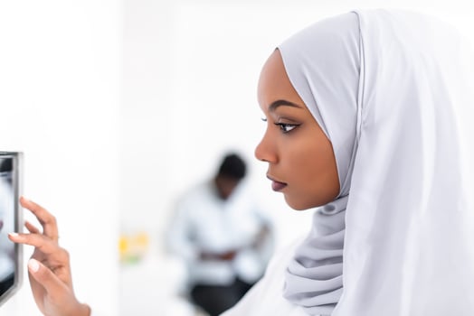 african woman using smart home screen photo