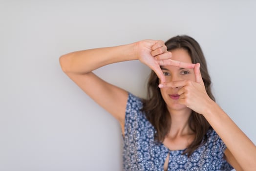 woman showing framing hand gesture photo