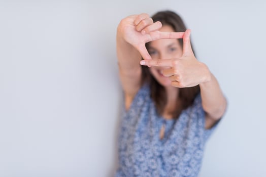 woman showing framing hand gesture photo