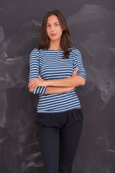 woman standing in front of chalk drawing board photo