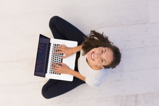 women using laptop computer on the floor top view photo