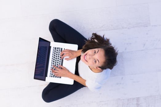 women using laptop computer on the floor top view photo
