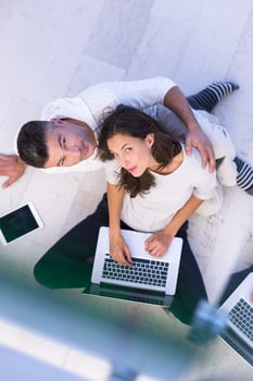 couple using tablet and laptop computers top view photo