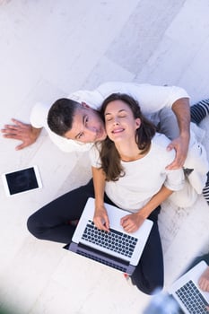 couple using tablet and laptop computers top view photo