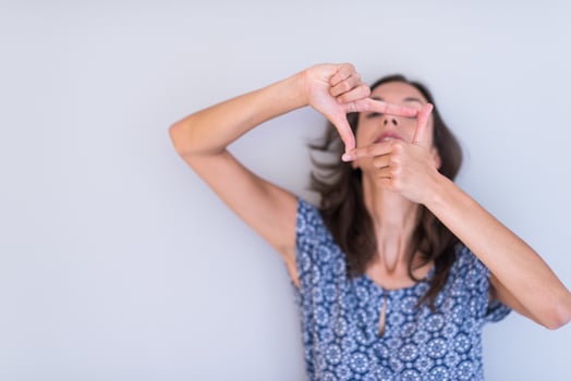 woman showing framing hand gesture photo
