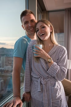 young couple enjoying evening coffee by the window photo