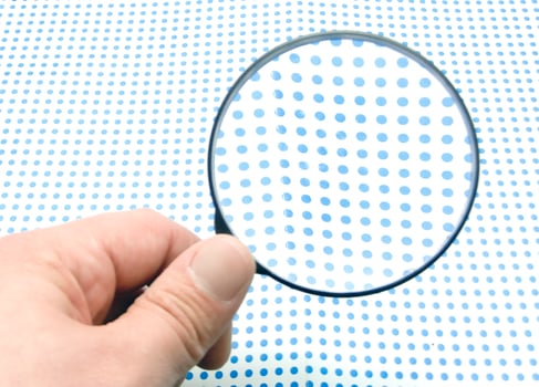 hand with magnifying glass photo