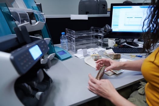 Bank employees sorting and counting paper banknotes photo