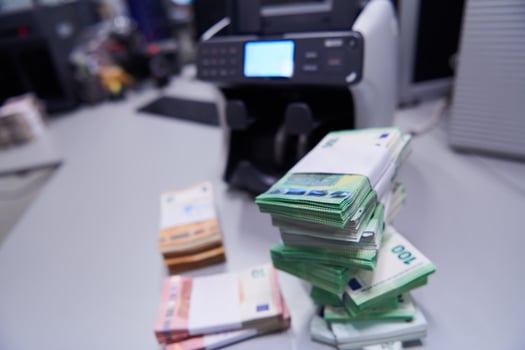 banknotes in front of electronic money counting machine photo