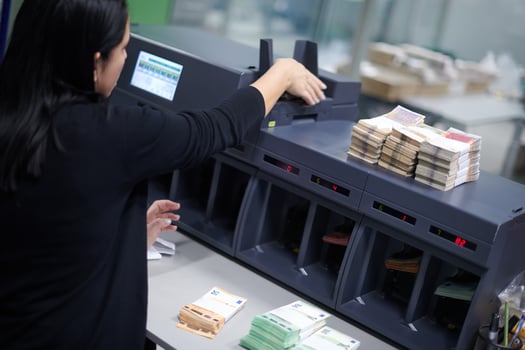 Bank employees sorting and counting paper banknotes photo