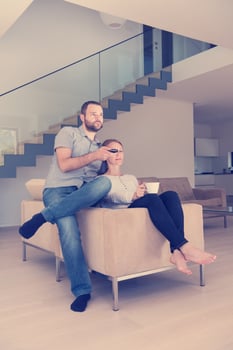romantic couple on the sofa watching television photo