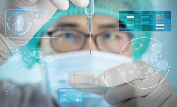 A man in a scientist's uniform was injecting a germicidal tray. The idea of inventing a vaccine to treat and prevent COVID-19 that is spreading around the world photo