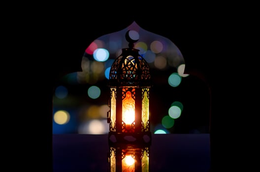 Lantern that have moon symbol on top with city bokeh light photo