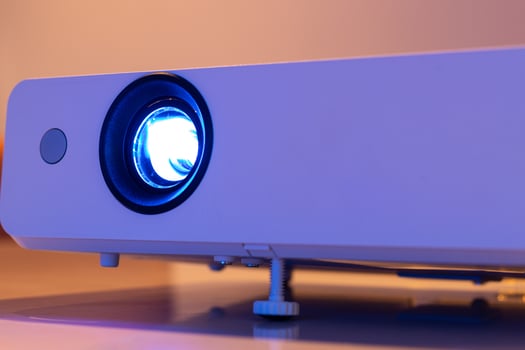 close up the lens of the projector with light for presentation in a dark room presention photo