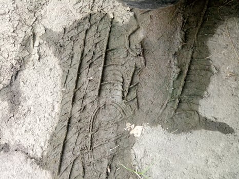 car tire prints on the mud photo