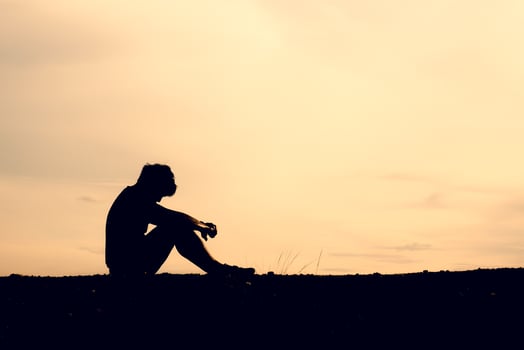 The silhouettes of men are sitting in despair. The concept was discouraged and hopeless. photo