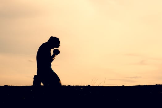Silhouettes of men sitting and praying for blessings. hope concept photo