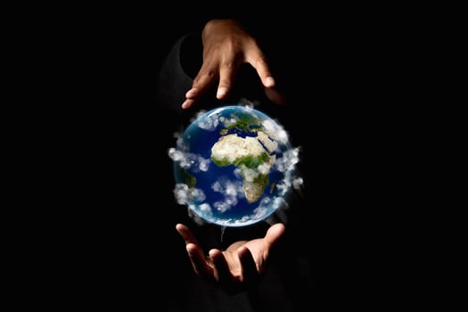 Environment concept. Earth in human hands on black background. Elements of this image furnished by NASA photo