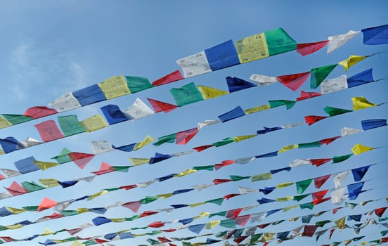 Tibetan prayer flags flying in the wind on a sunny day photo
