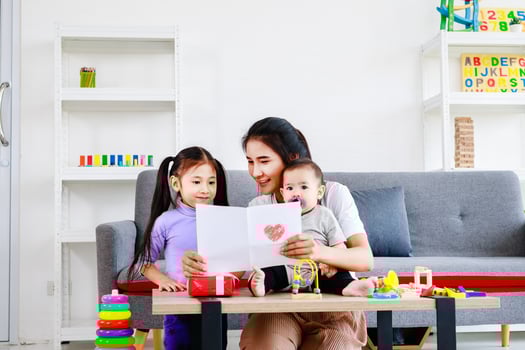 cute daughter sends love mom cards to mother and kiss while take care baby, Mother day concept photo