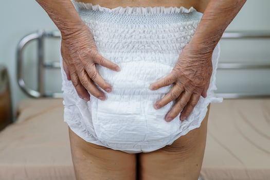 Asian elder senior woman patient wearing adult incontinence diaper pad in hospital. photo