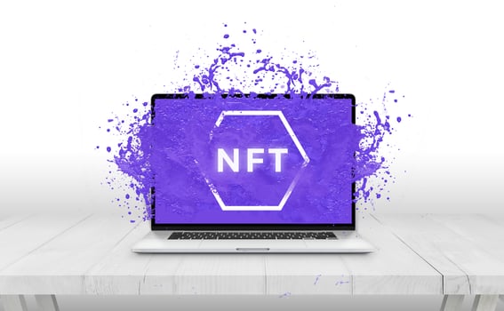 NFT non-fungible token text comes out with purple liquid from laptop display concept photo