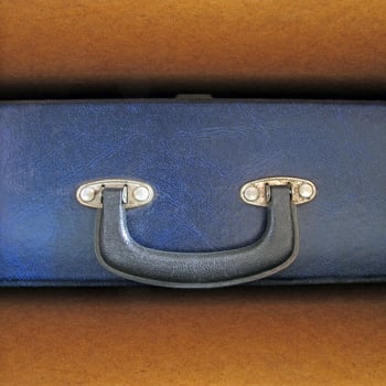 old blue briefcase in wooden shelf. photo