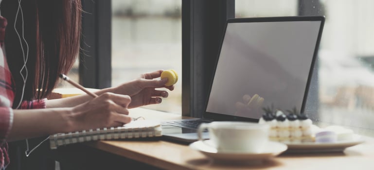 Cropped image Young female freelancer blogger influencer writing notes on her diary photo