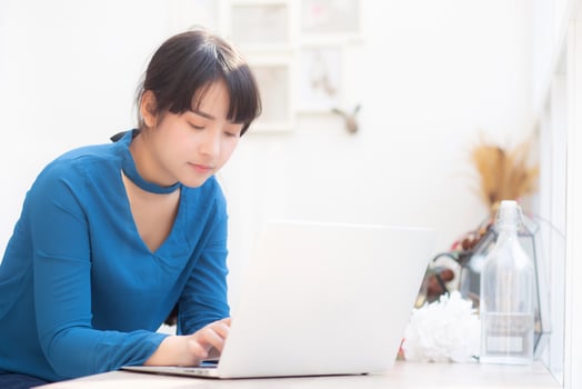 Beautiful portrait asia young woman working online on laptop sitting at cafe shop, professional female freelance using notebook computer, business and communication concept. photo