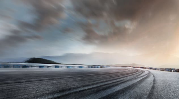 Empty long mountain road to the horizon on a sunny summer day at a bright sunset - speed motion blur effect. photo