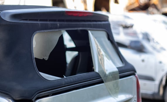 Damaged roof material on the back of the convertible. Vandalism, thieves cut the roof of a convertible from behind. Theft of things from the car. Criminal incident. Car burglary. photo