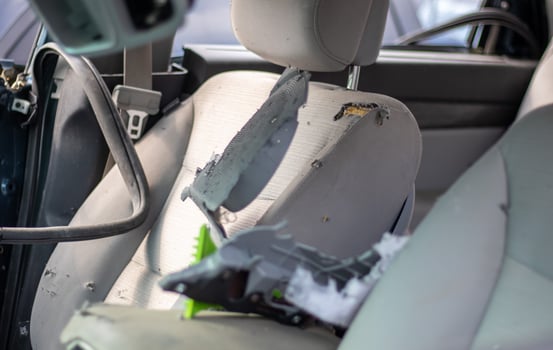 The interior of the car is damaged after the accident, broken glass on the seat. Damaged car interior. photo