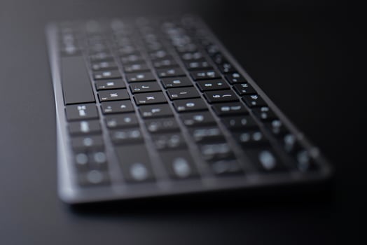 space gray keyboard on a black background photo
