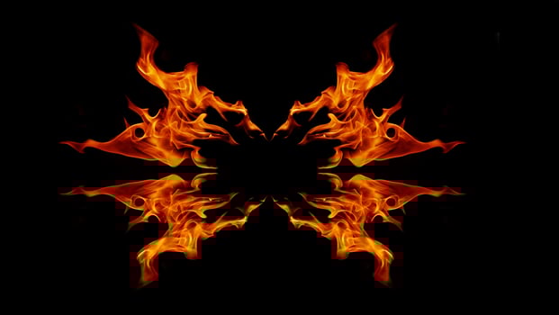 A beautiful flame shaped as imagined. like from hell, showing a dangerous and fiery fervor, black background photo