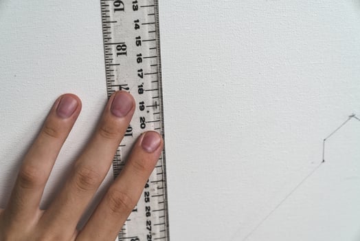 hand holding ruler with canvas background photo
