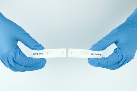 Medical personnel showing Covid-19 positive and negative test result with SARS CoV-2 Rapid antigen test kit ATK. Coronavirus infectious protective concept. photo
