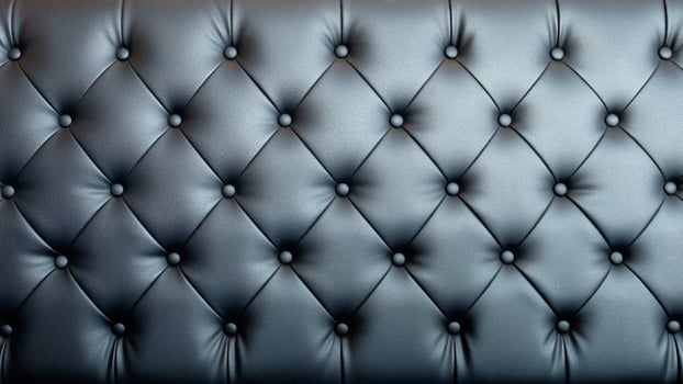 Black artificial leather sofa with rivets texture for background. photo