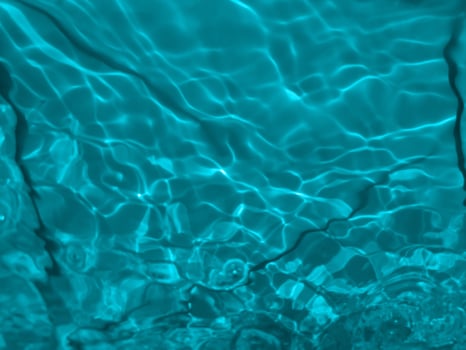 Defocus blurred transparent blue colored clear calm water surface texture with splashes and bubbles. Trendy abstract nature background. Water waves in sunlight. Blue water background. photo