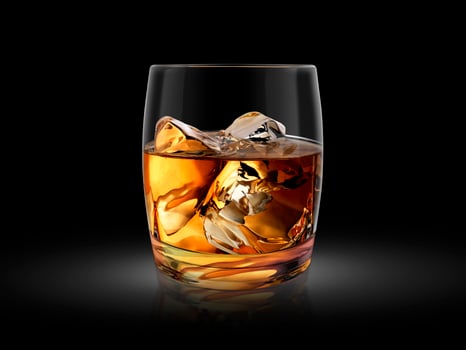 Glass of whiskey nestled on dark background. 3d render photo